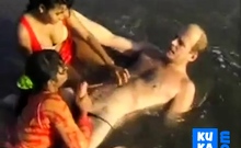 2 Indian girls with white guy in beach have fun blowjob..