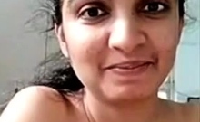 Horny busty indian milf strips nude to show round tits